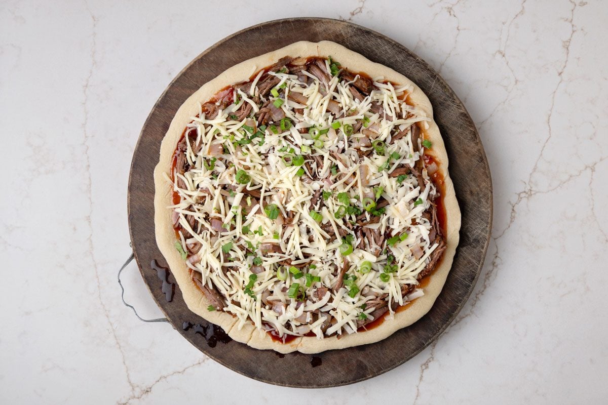 Top with shredded brisket; onion; cheese and remaining 1/4 cup green onions and 1/4 cup cilantro