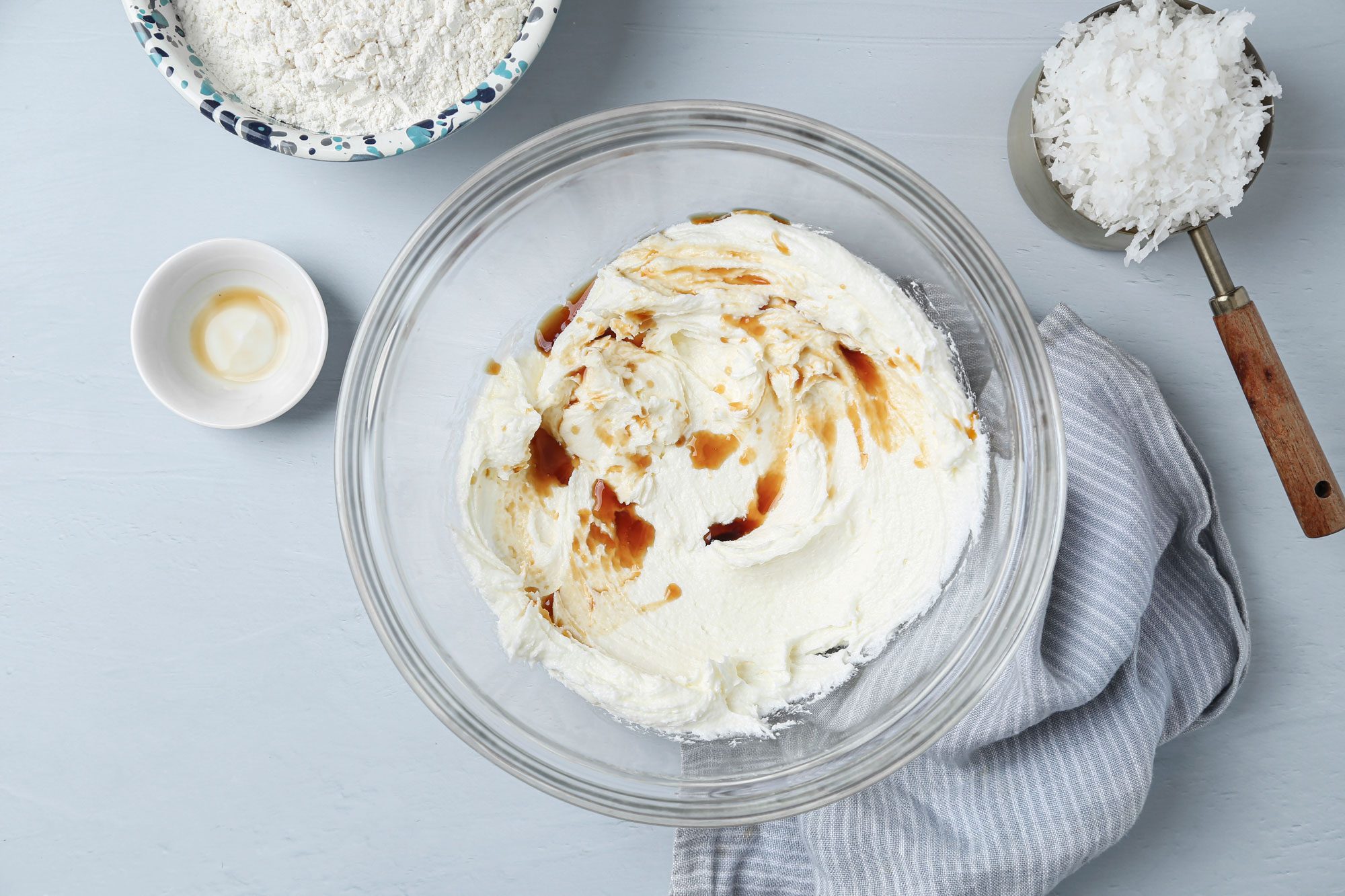 Beat in vanilla; gradually beat flour into creamed mixture and Stir in coconut