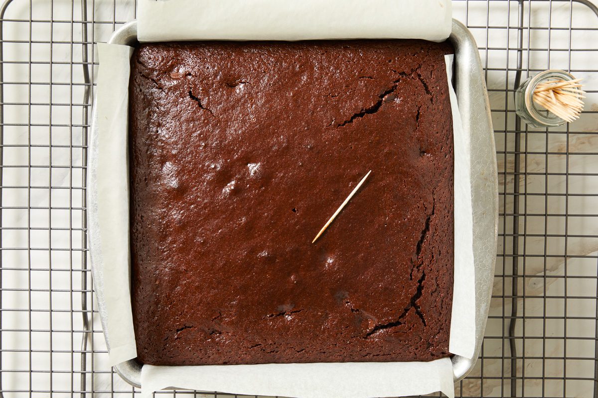 toothpick on baked brownie batter in pan