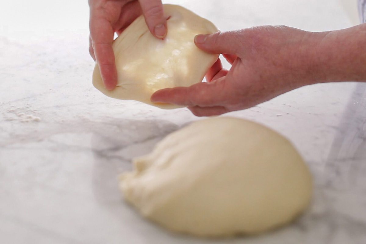 stretching dough to make a window pane