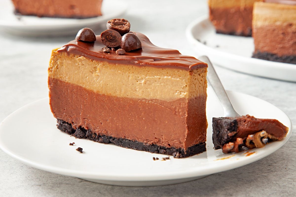 wide shot of layered mocha cheesecake slice topped with chocochip