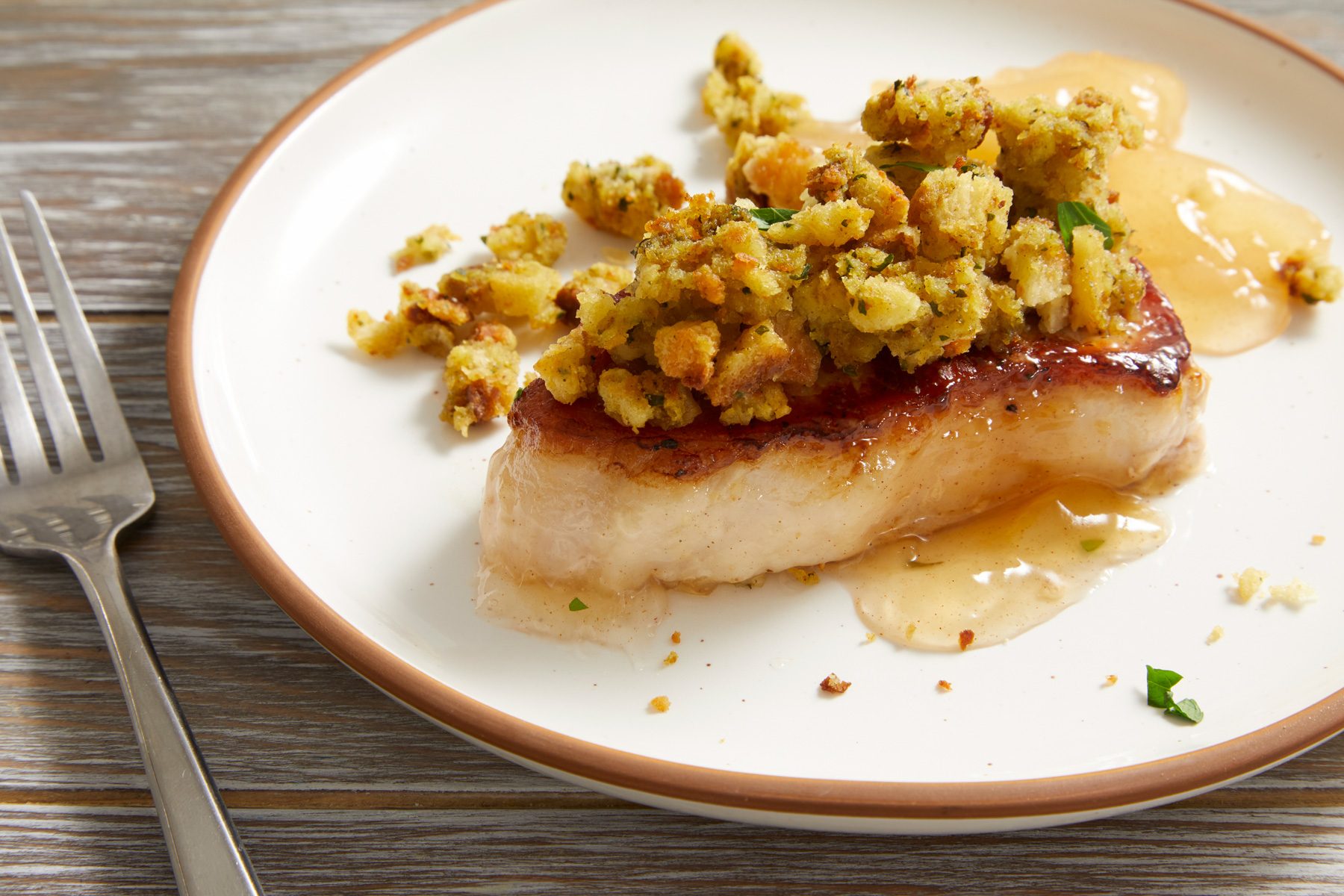 Close up shot of Pork Chops with Apples and Stuffing;