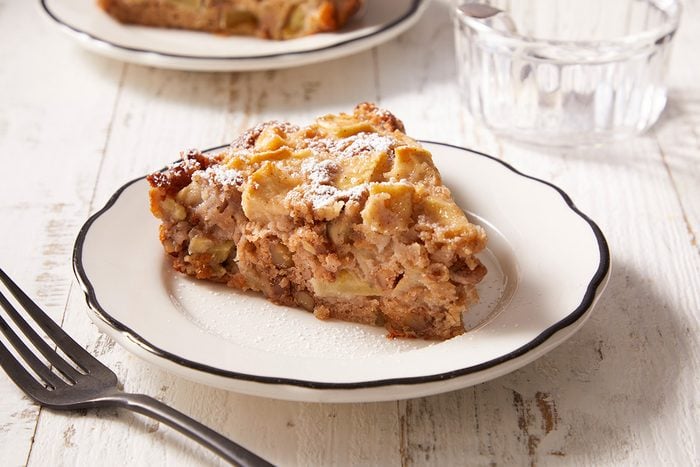 Close up shot of Swedish Apple Pie sprinkled with confectioner's sugar on top