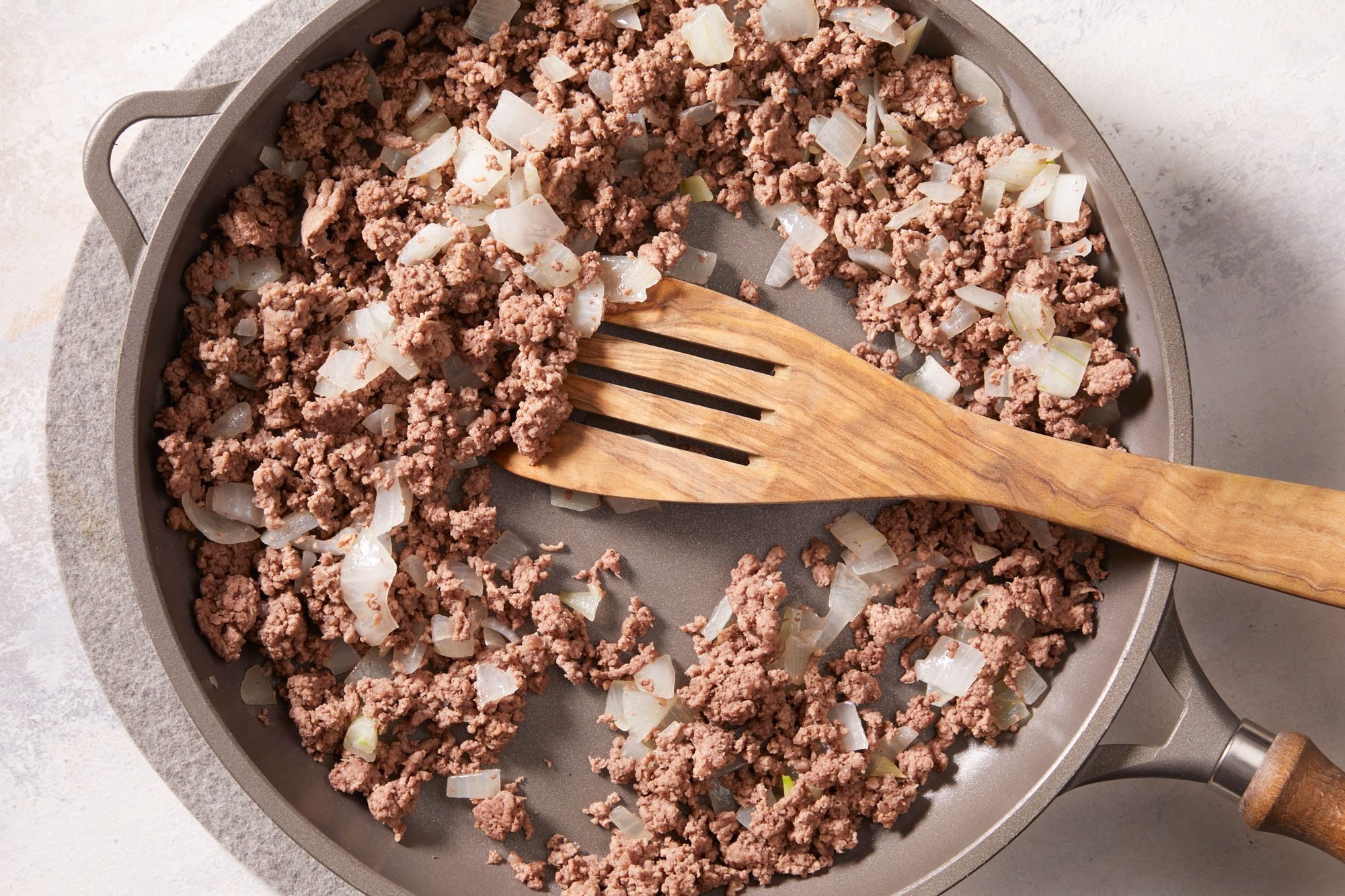 In a large skillet, cook beef and onion over medium heat until meat is no longer pink,