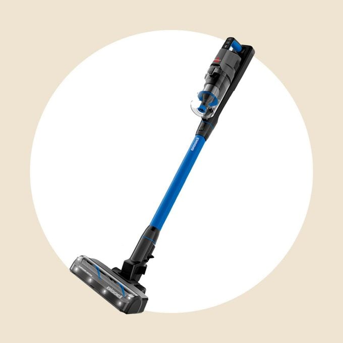 Bissel stick vacuum on a white and tan background
