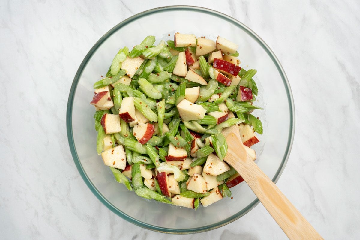 Overhead shot of toss to coat; Refrigerate covered for 1 hour; Stir before serving; all set on a marble surface;