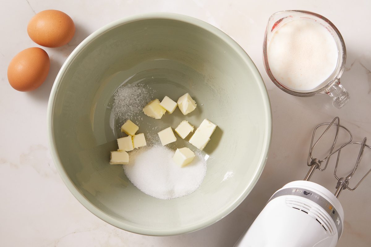 eggs next to butter and sugar in a bowl