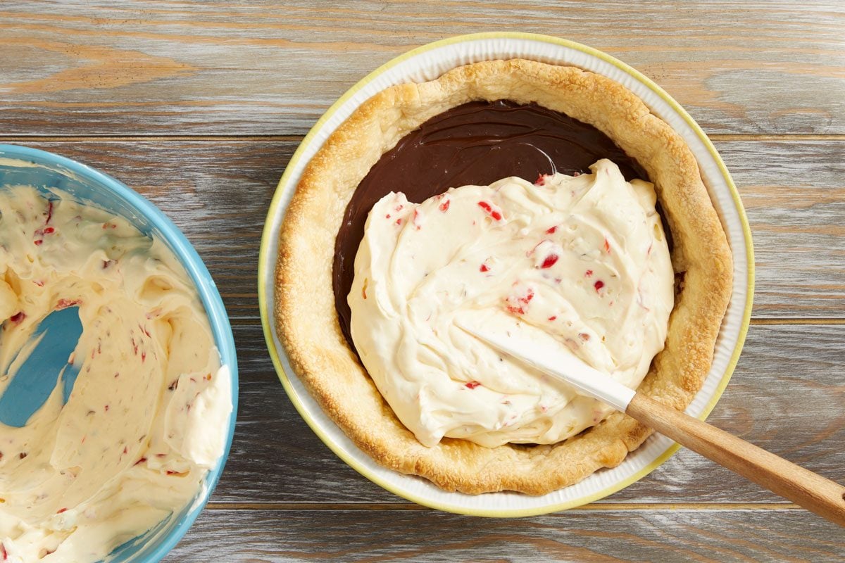 Fold in whipped cream. Stir in chopped cherries and almonds.