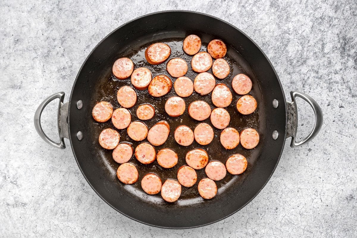 In a large skillet brown the sausage in 1 teaspoon oil