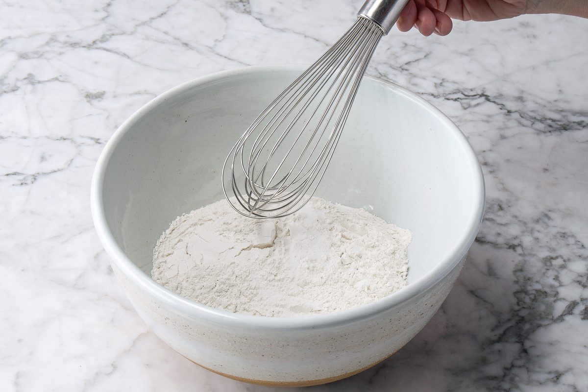 whisking salt and flour in a bowl