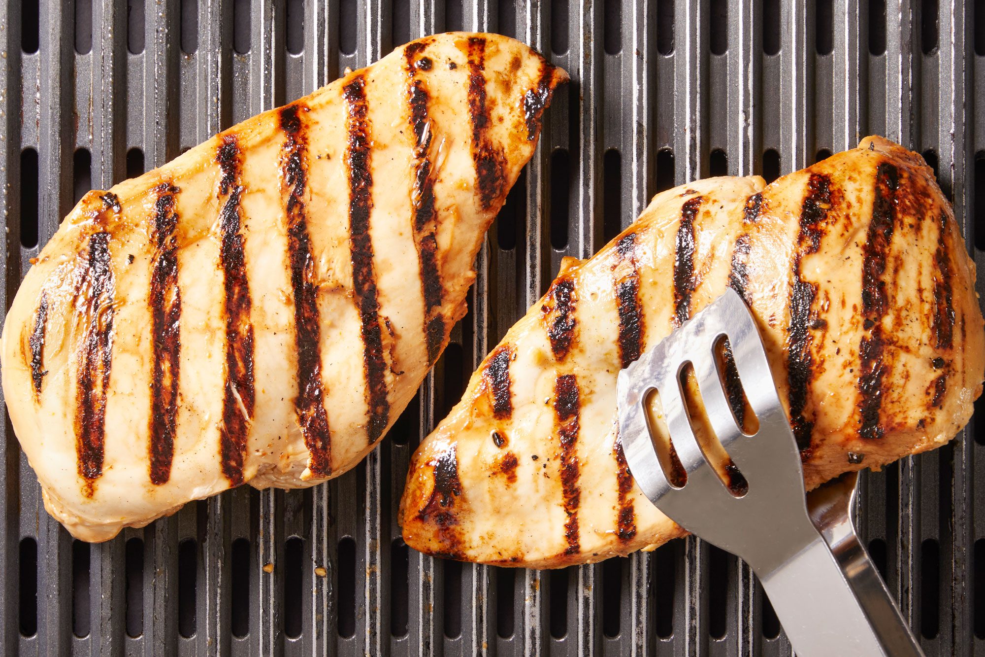 Grill chicken, covered, on a greased grill rack