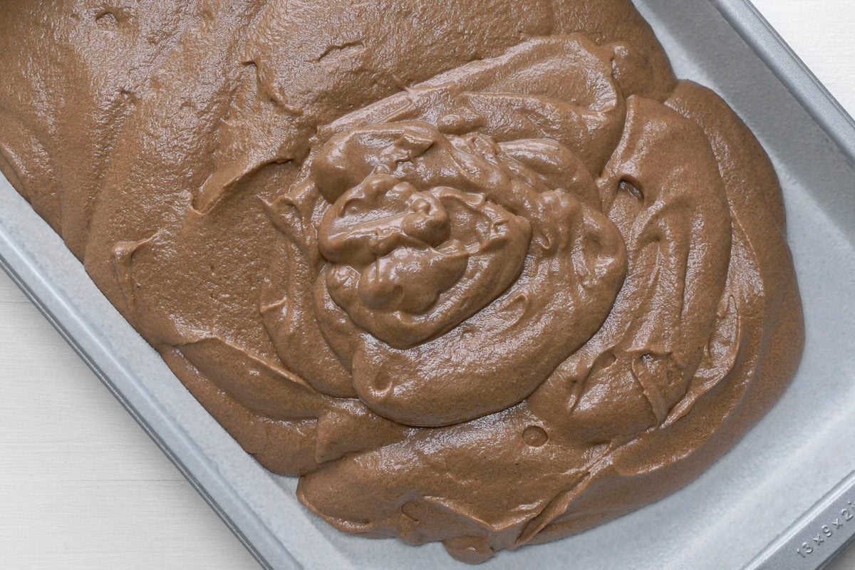 chocolate cake batter poured into a greased and floured 13x9-inch baking pan