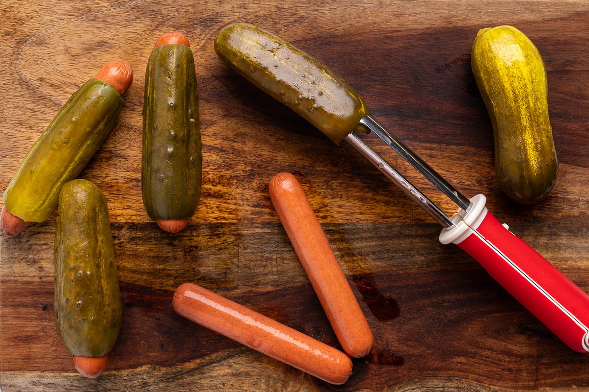 Hot dogs are putting inside the pickles in the centre
