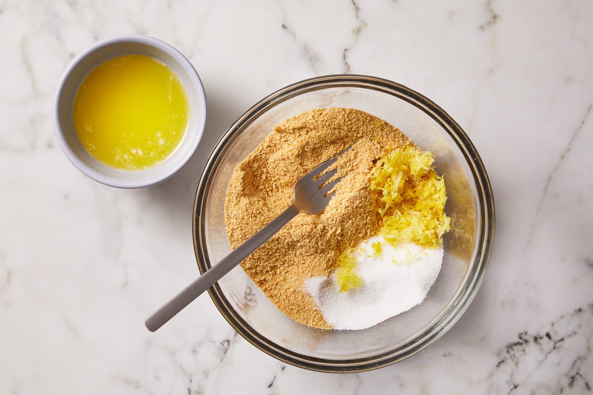 graham cracker crumbs, butter and sugar in a bowl