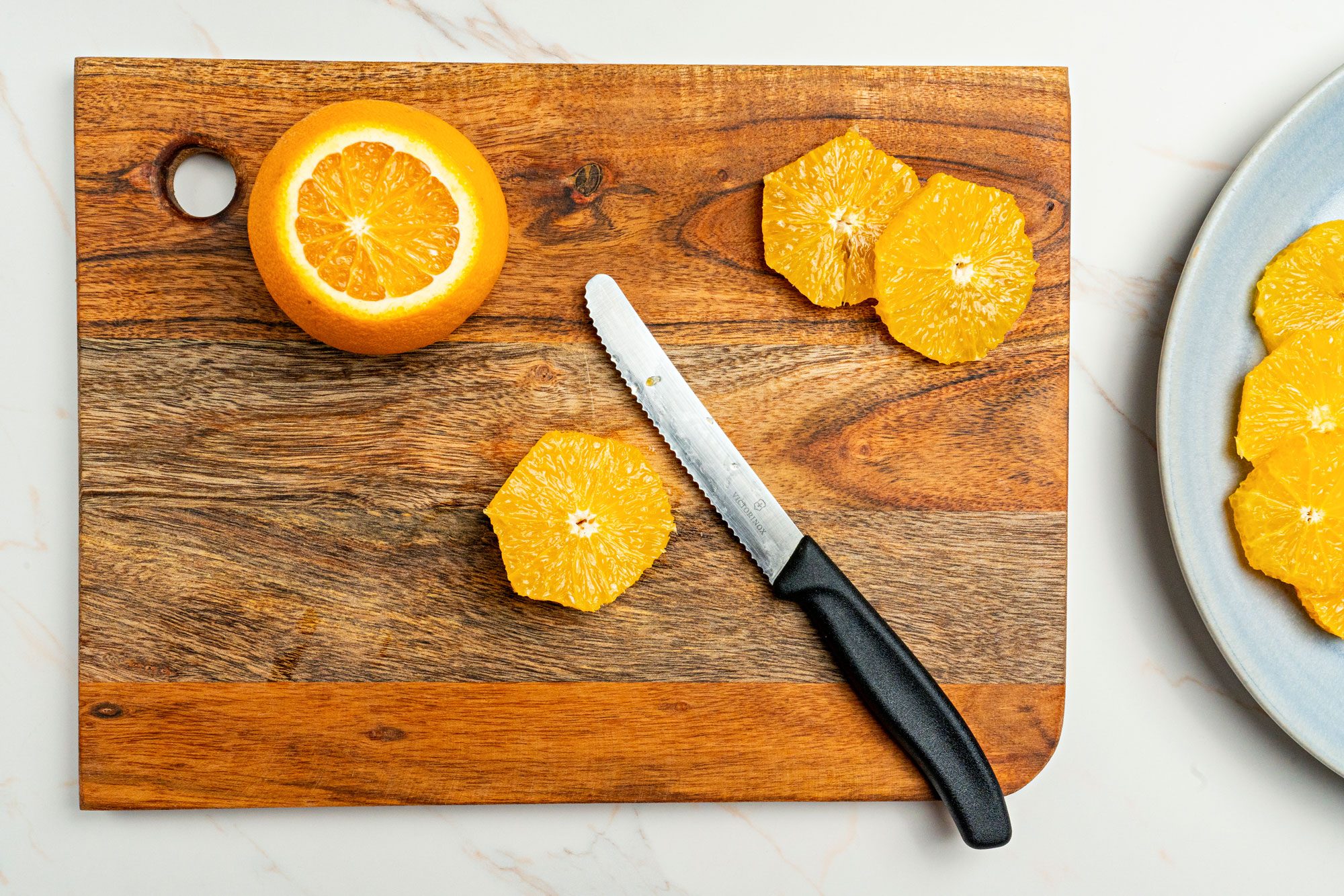With a knife, remove peel and outer membrane from oranges