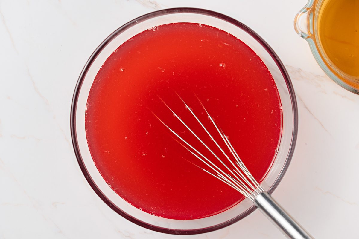 Ginger ale next to rhubarb punch mixture in a bowl