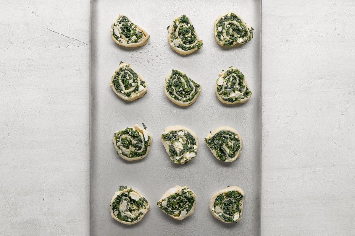 Place cut side down on greased baking sheets.