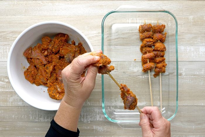 Threading beef onto metal or soaked wooden skewers