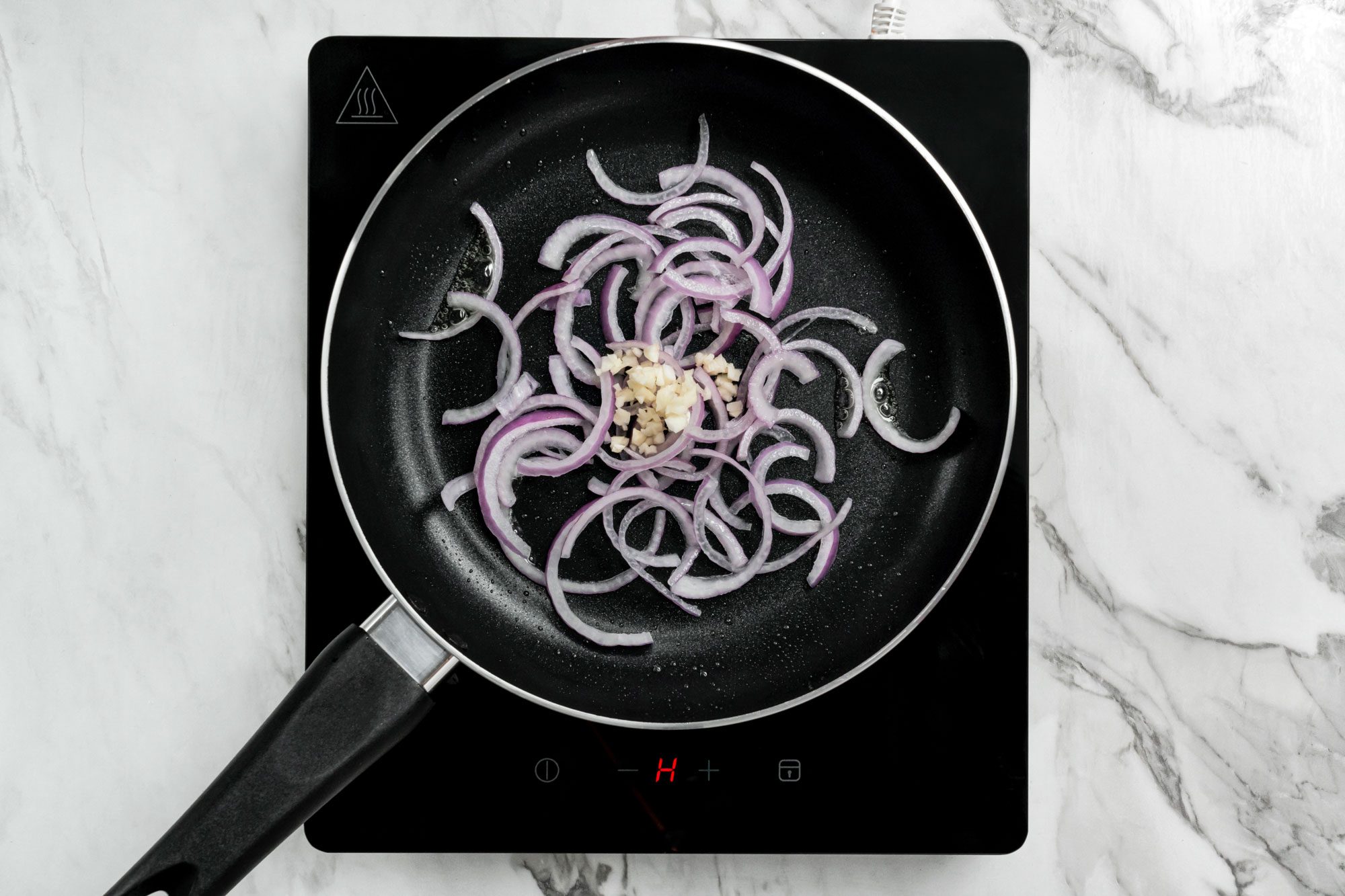 In the same skillet, stir-fry onion and garlic