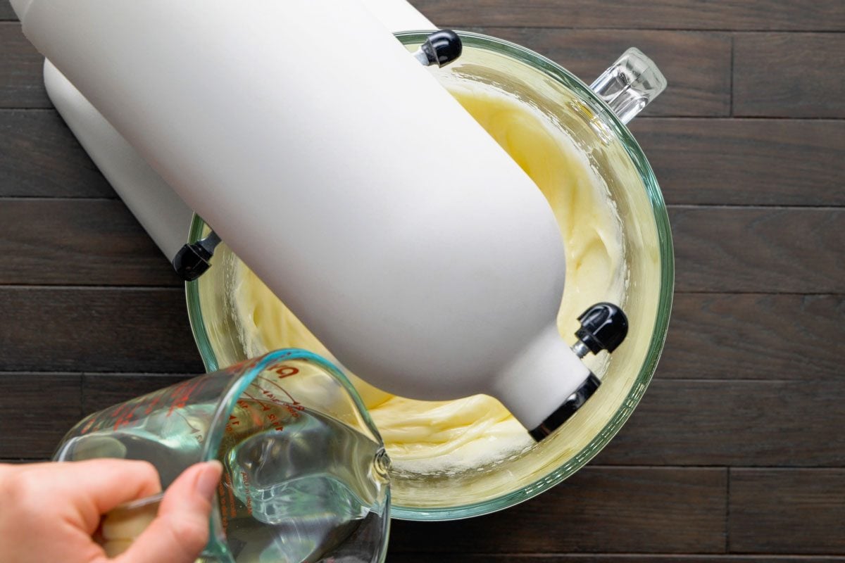Overhead shot of gradually beat in oil; all set on a dark brown wooden surface;