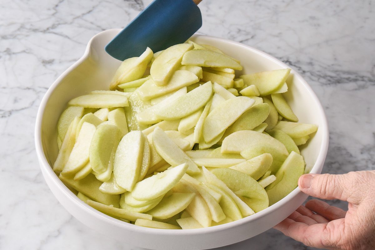 apple slices tossed with lemon juice in a bowl