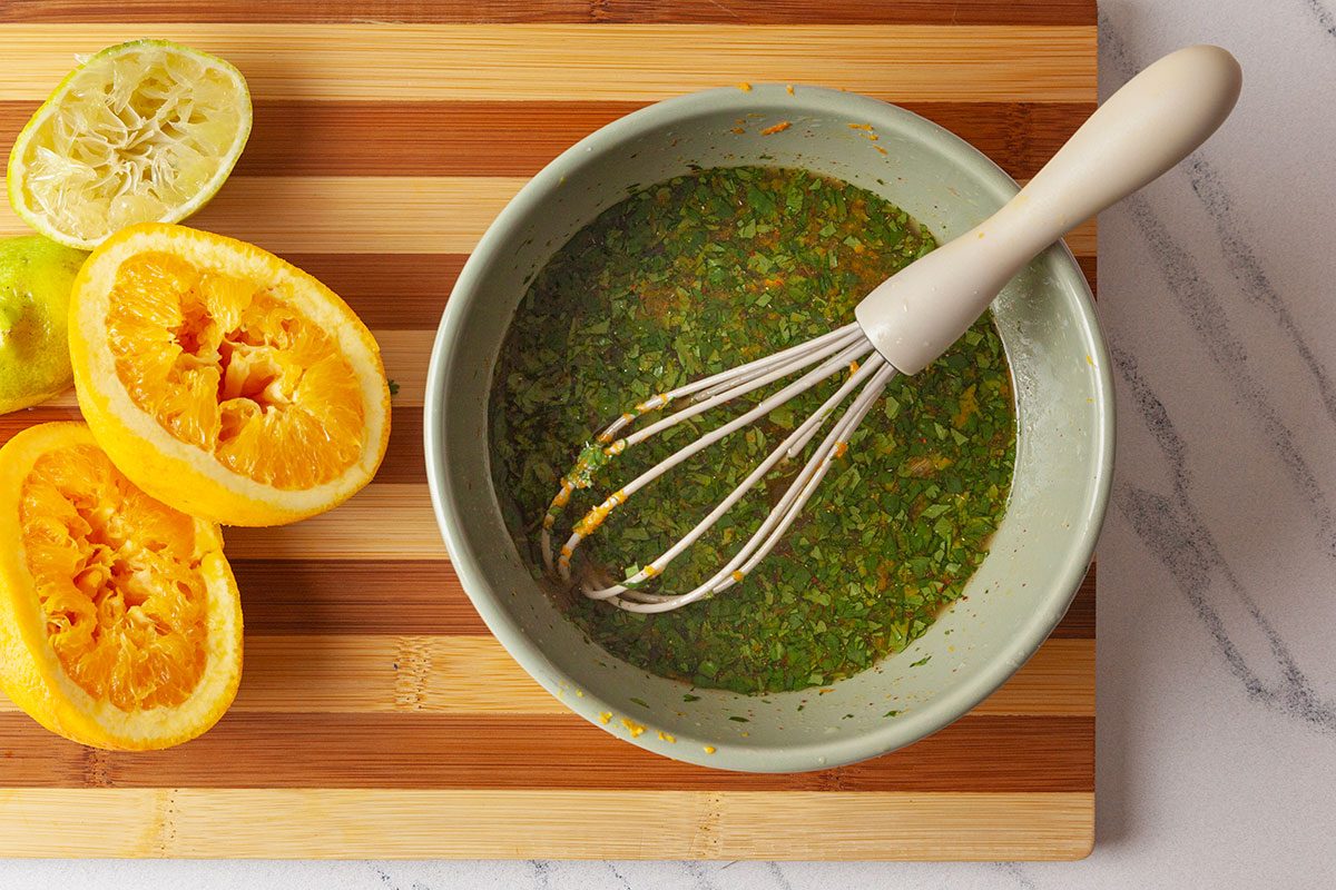 rice vinegar, white balsamic vinegar, brown sugar, white pepper, ground coriander, celery salt, ground ginger, chili powder, cayenne pepper, chopped cilantro, slivered almonds, orange juice and zest, lime juice and zest and salt are mixed together to make a salad dressing