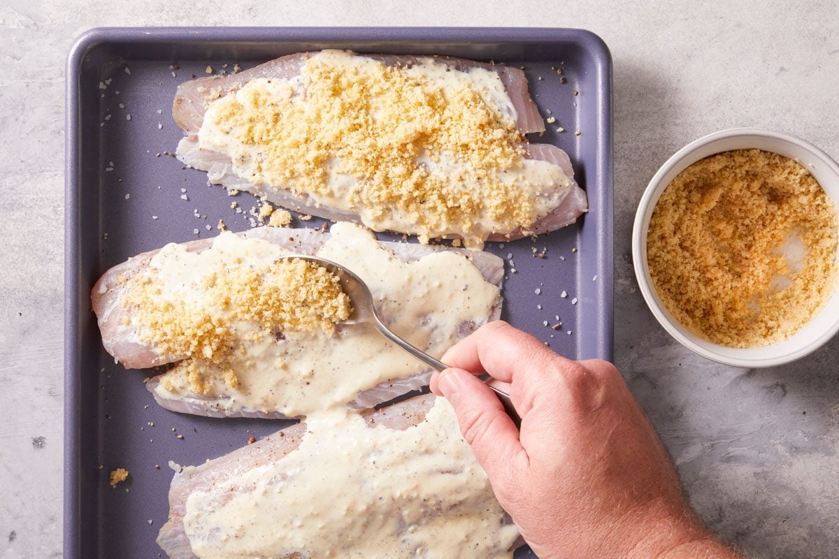 Toss bread crumbs with melted butter and remaining cheese;