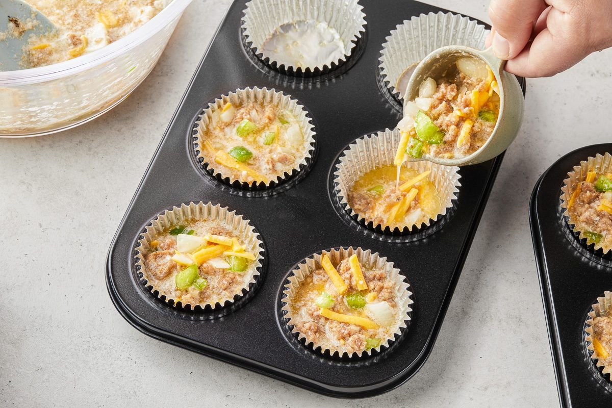 filling muffin tin with egg mixture