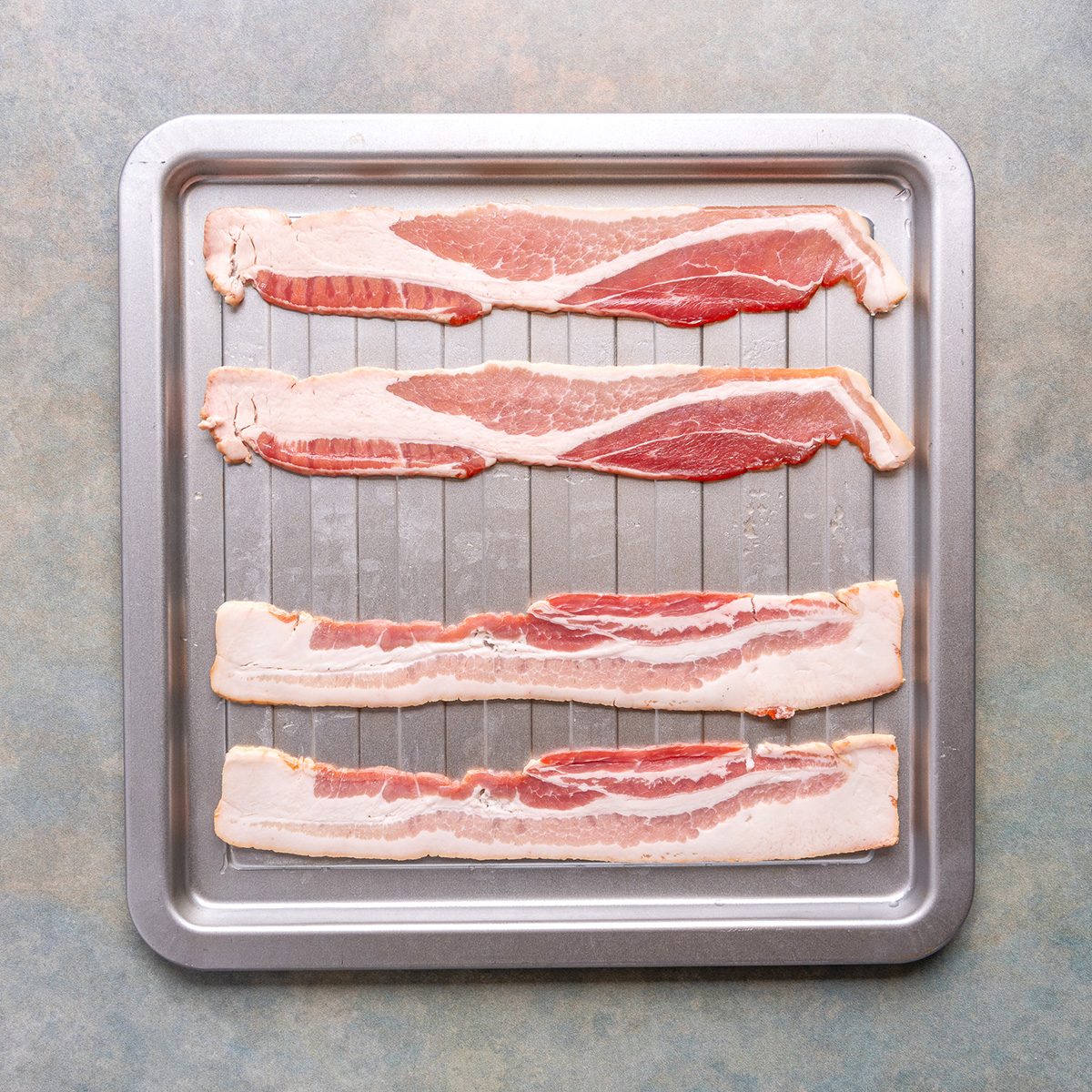 Costco's Coleman Bacon and Kirkland Bacon placed raw on a plate