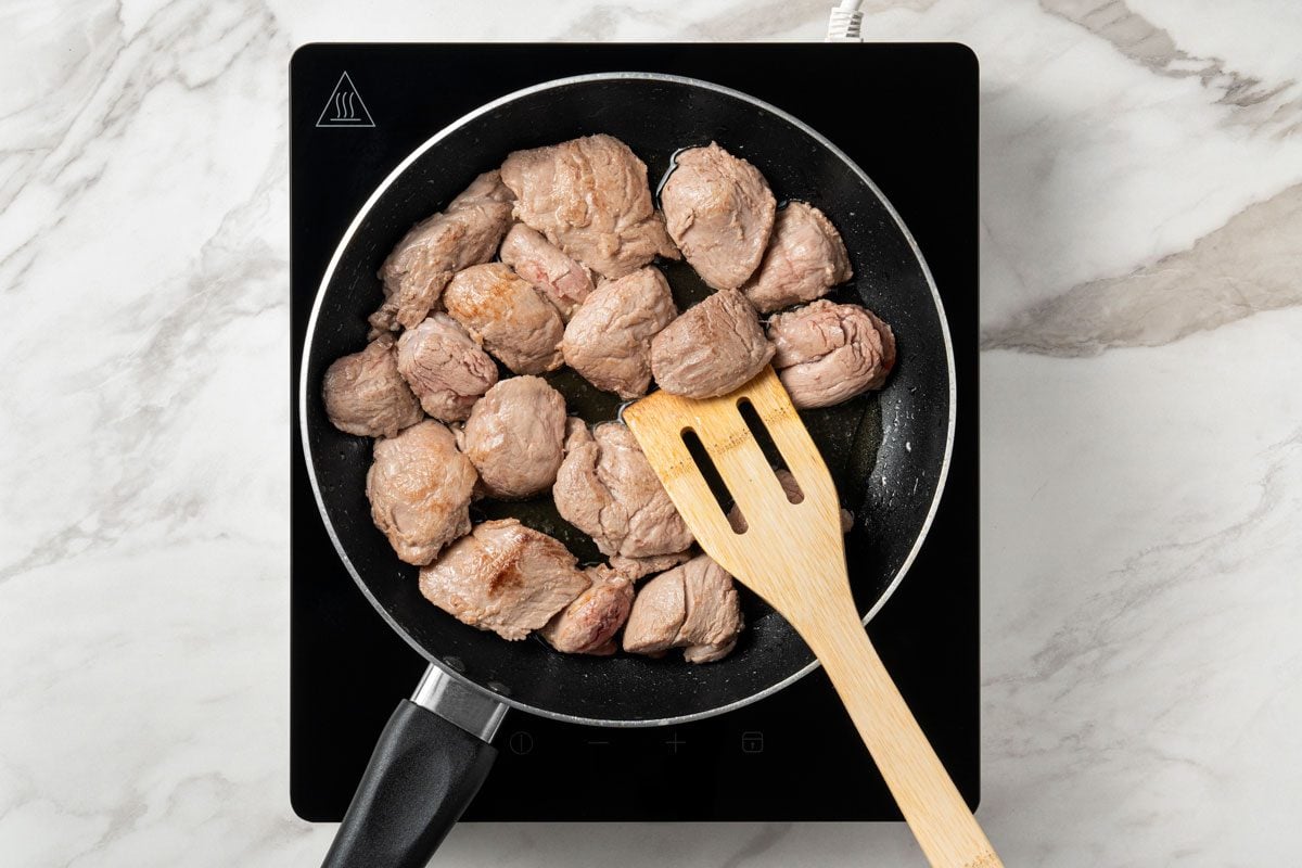 In the same pan, stir-fry pork in remaining oil