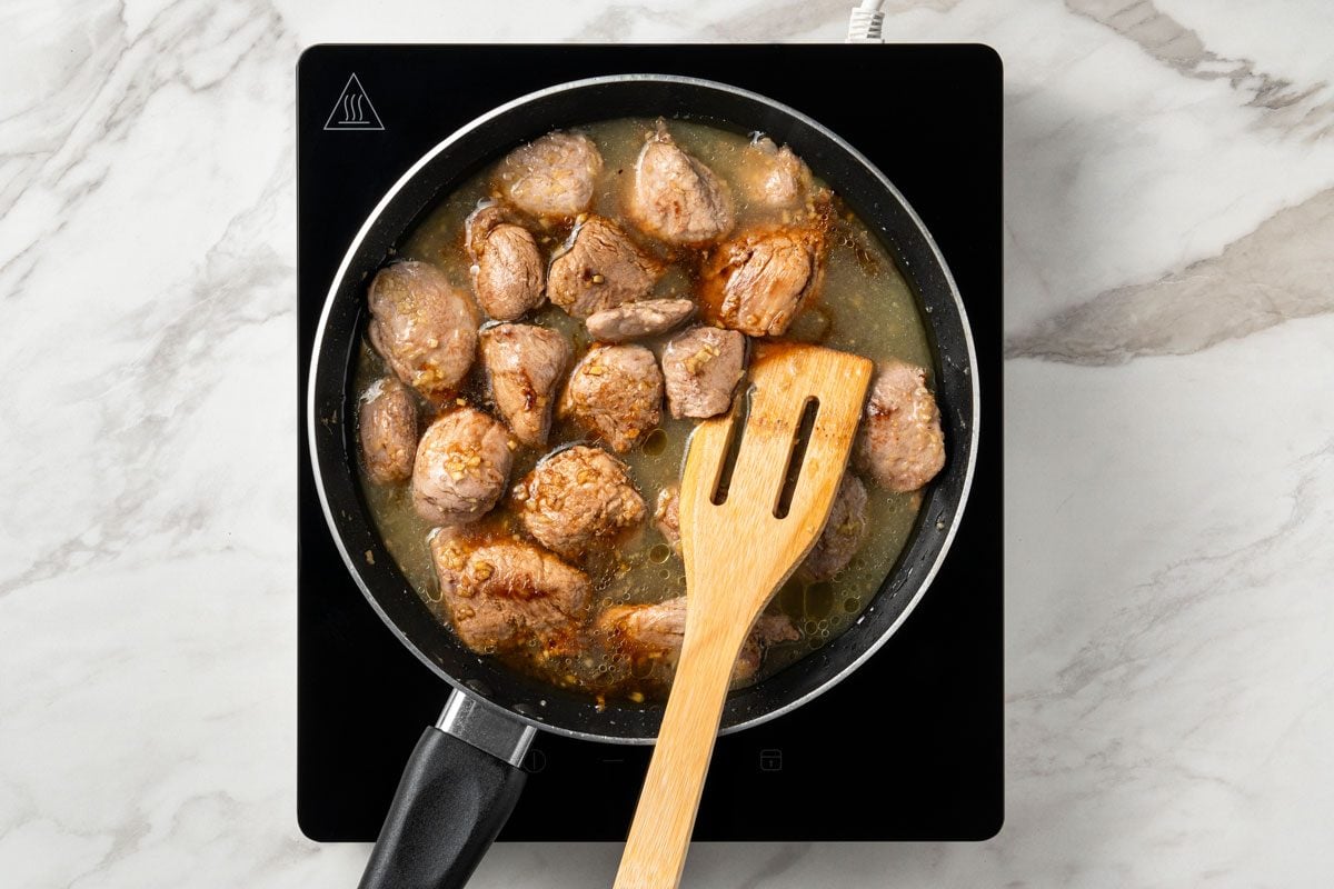 Stir in 3/4 cup broth and soy sauce.