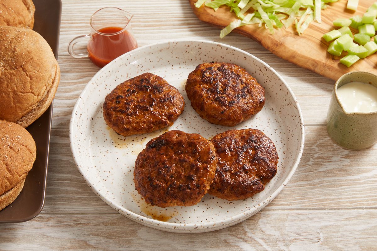 patties on a plate next to burger buns