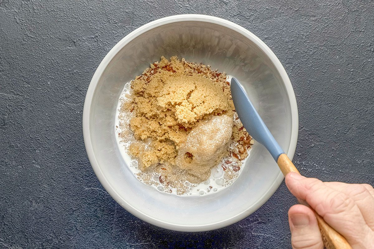 Overhead shot of combine filling ingredients; spatula; dark surface