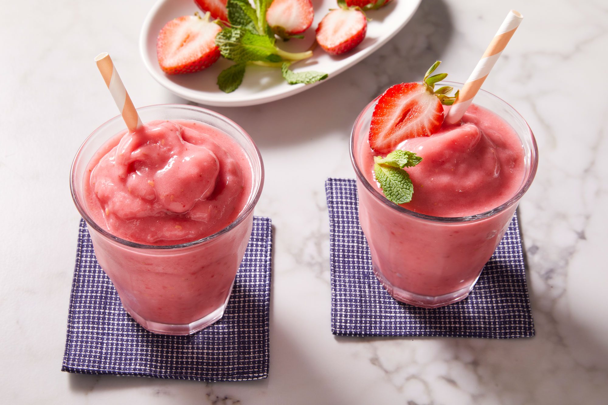 3/4 shot of Fruity Red Smoothies garnished with mint sprigs and fresh strawberries