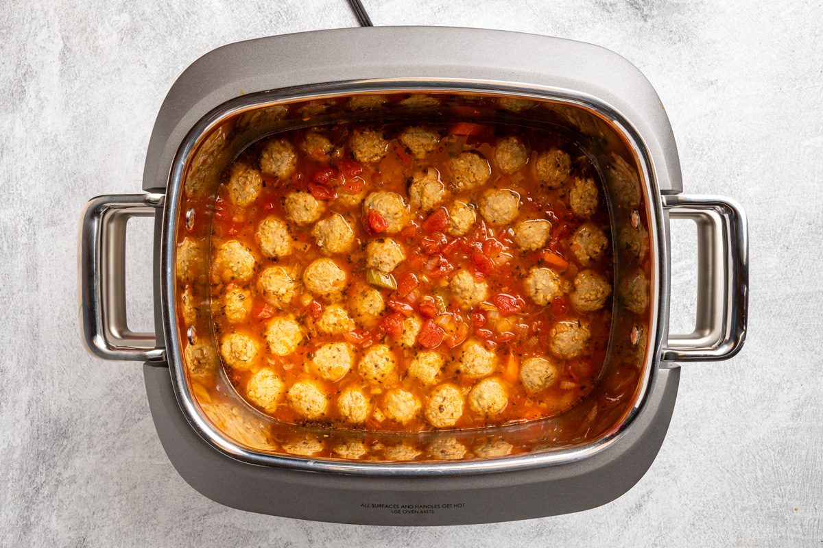 carrots, celery, onion, bay leaf, Italian seasoning, pepper, meatballs, broth, tomatoes, water and wine in a 6-quart slow cooker
