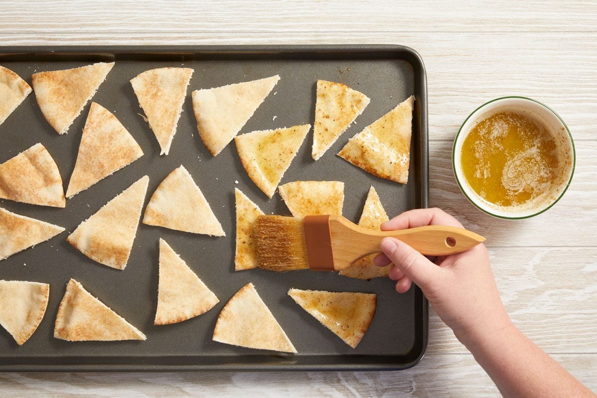 Combine the butter, lemon pepper, cumin and garlic salt; brush over pita wedges.