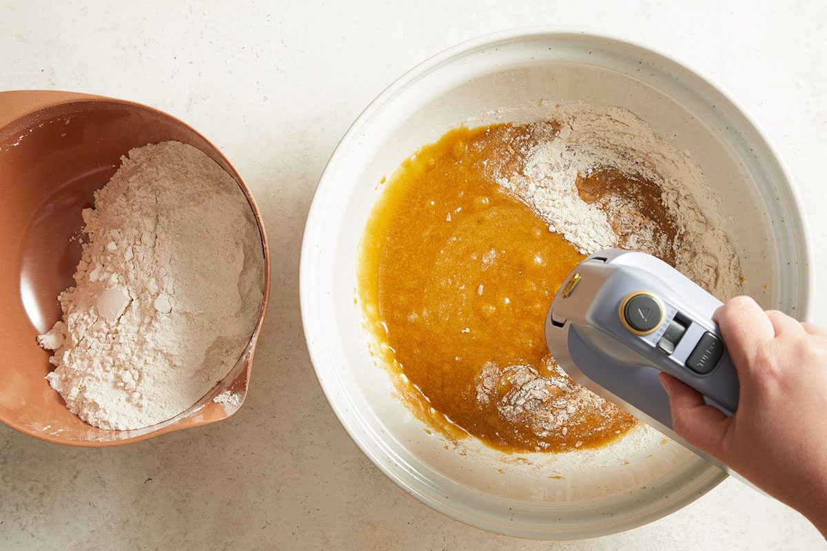 Mixing flour with egg to make cookie dough