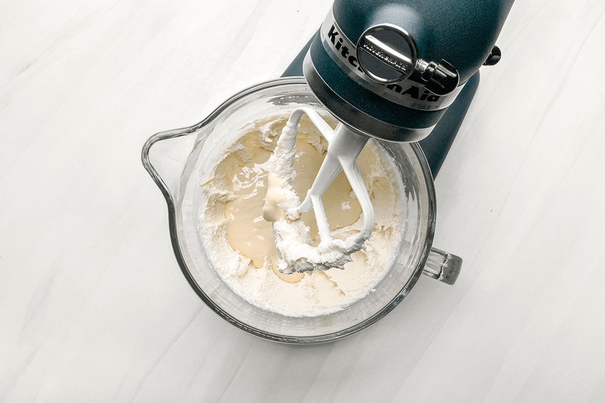 In the bowl of a heavy-duty stand mixer, cream butter, shortening and sugar until light and fluffy