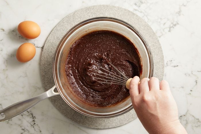 Mixing vanilla and espresso powder in sourdough brownie batter.