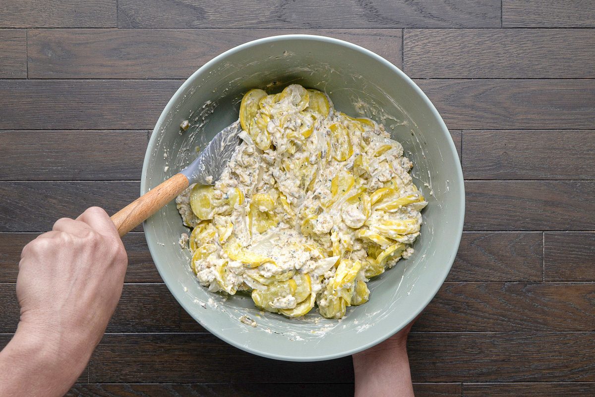 squash mix being folded in with stuffing mix