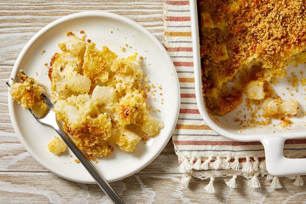 Overhead shot of a serving of Turnip Bake on a white plate with a fork