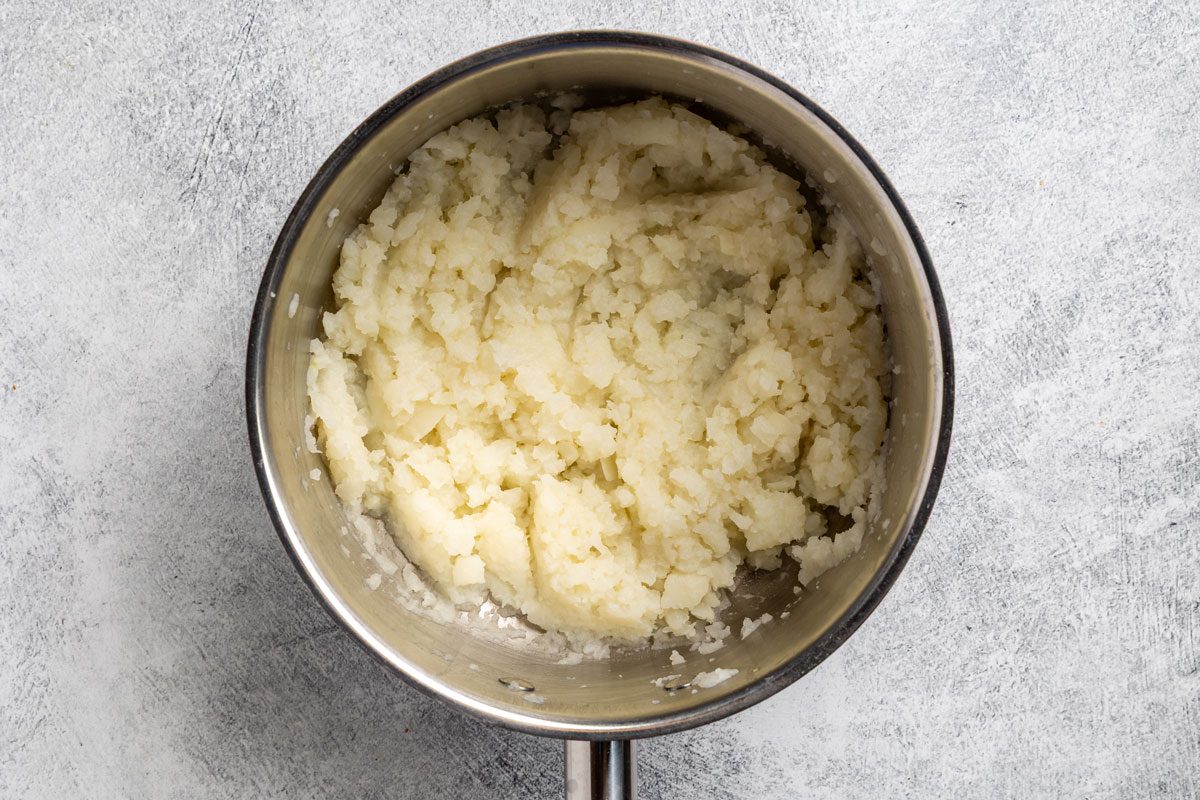 mashed turnip cubes in a large saucepan