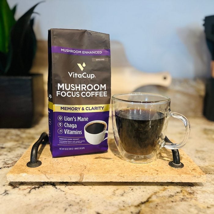 A bag of VitaCup coffee next to a glass coffee mug