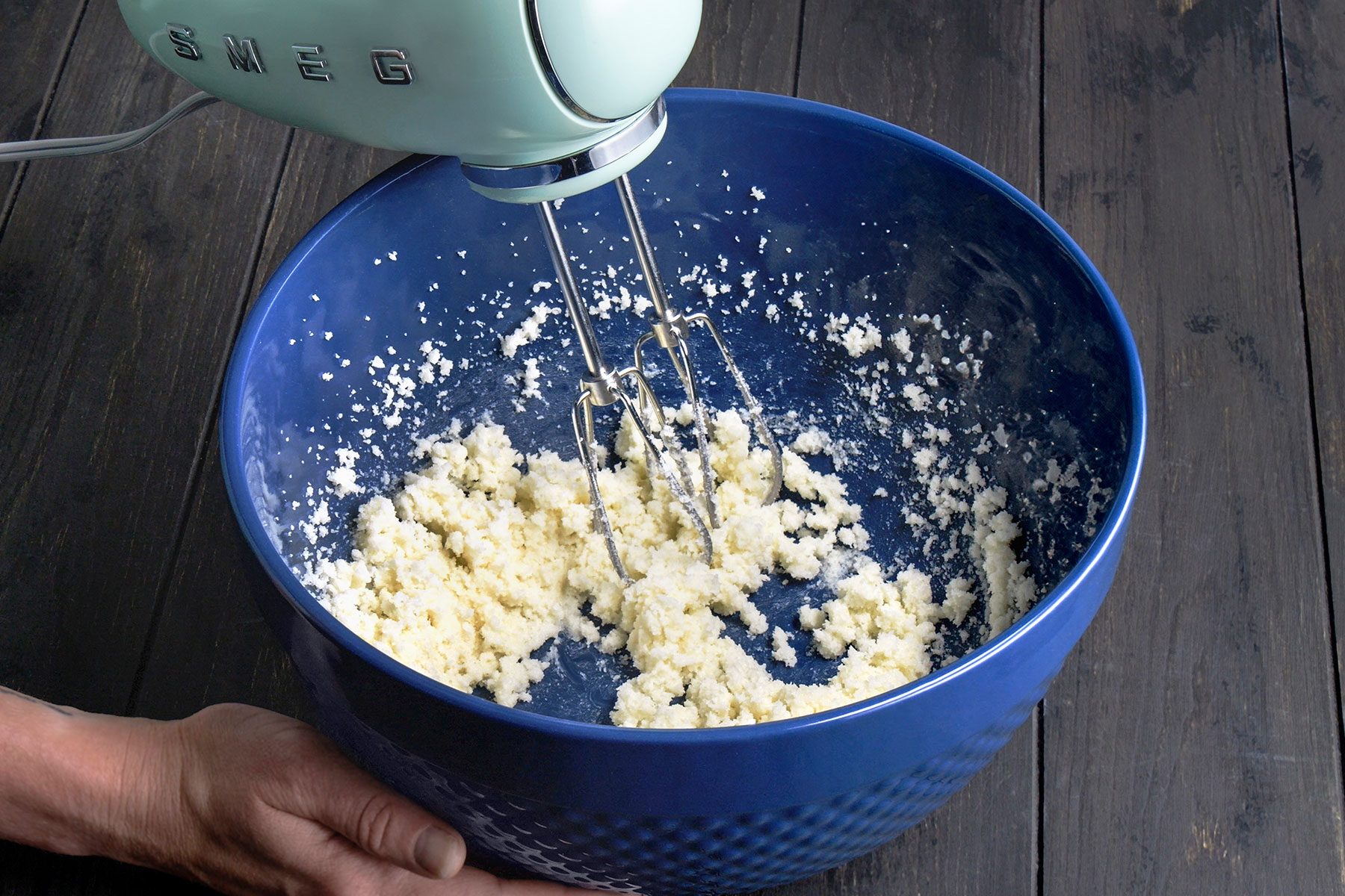 Using mixer to cream the sugar and butter until they're light and fluffy.