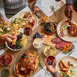 Diverse group of friends enjoying homemade food at festive dinner table