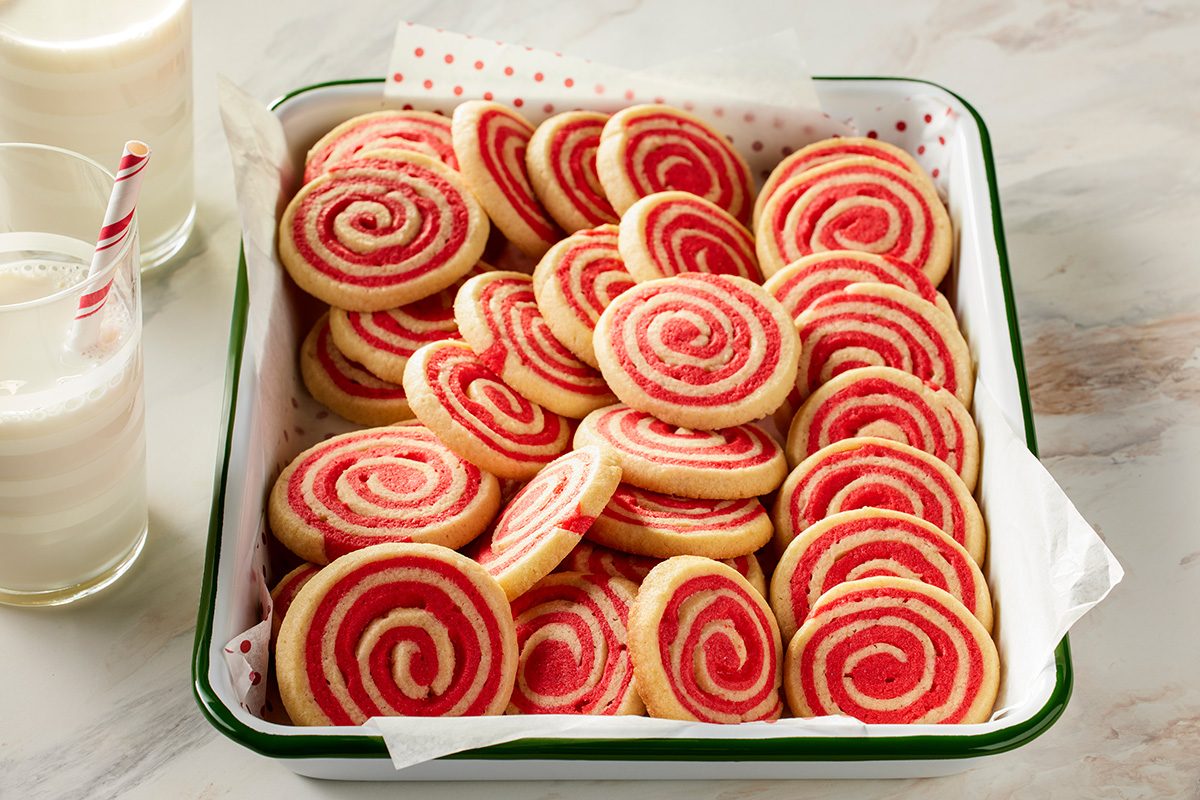 3/4 angle view shot of a tray of peppermint pinwheels on parchment paper
