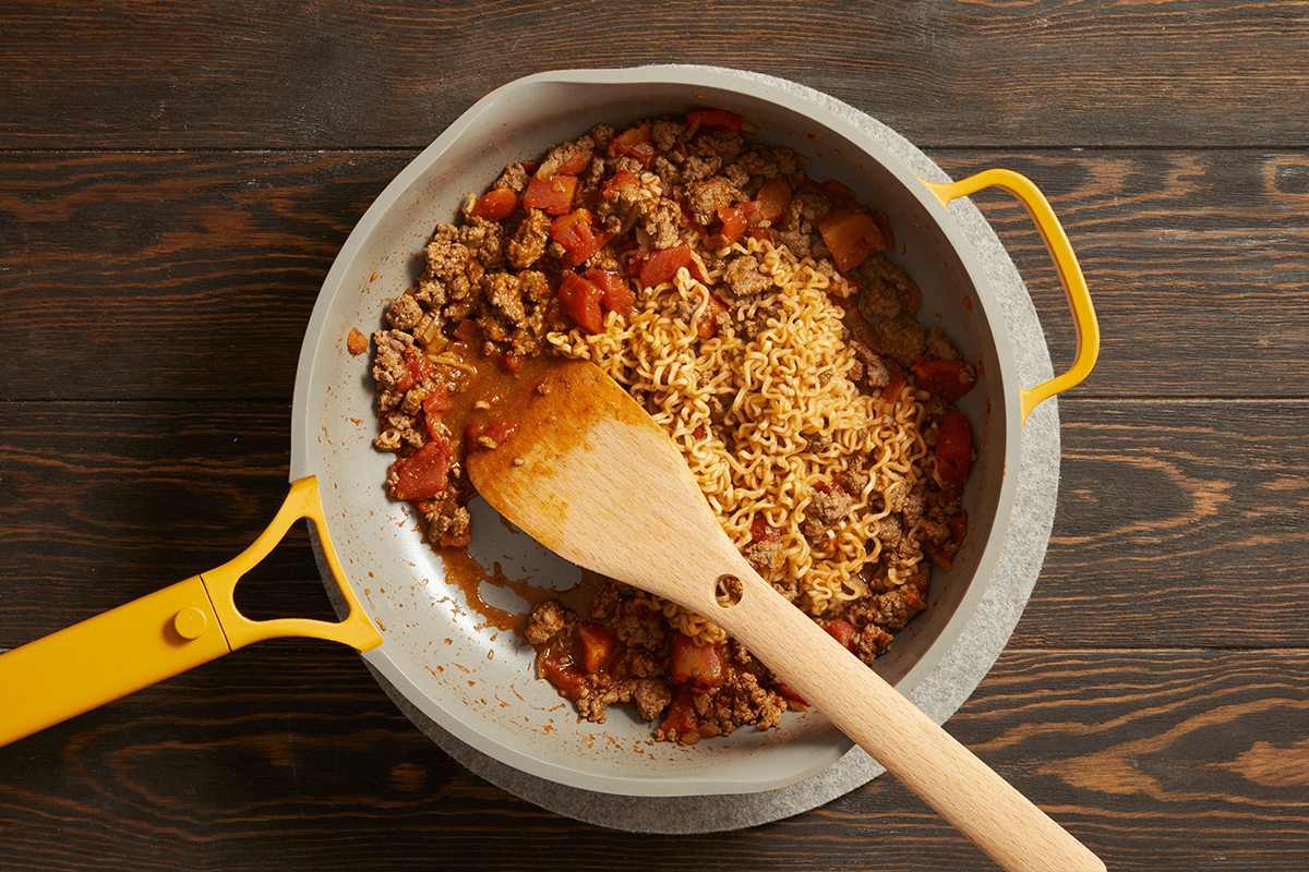 Adding ramen noodles to the skillet