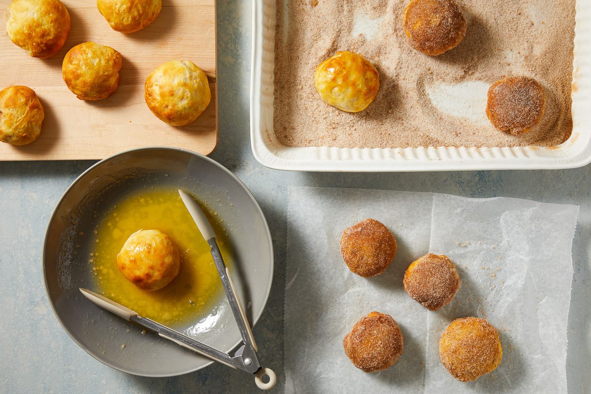 apple bombs being coated with sugar cinnamon mixture