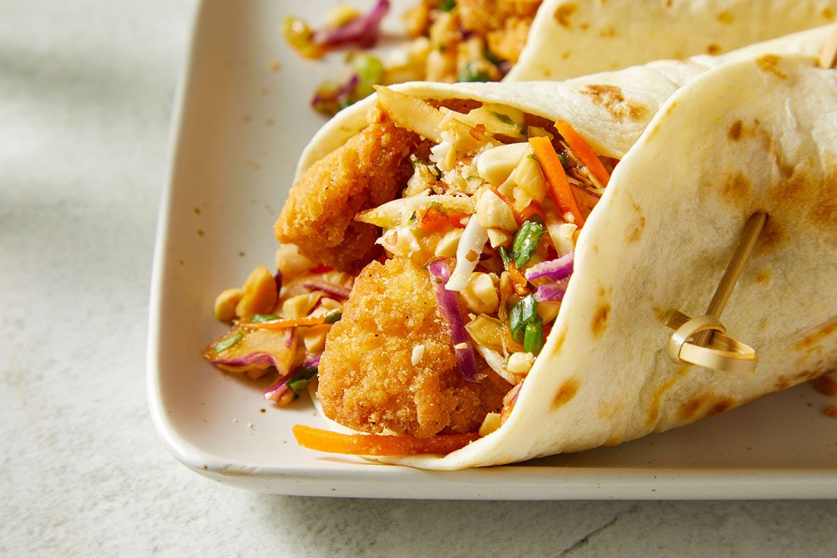 Close-up shot of Asian Chicken Crunch Wraps served on a white plate.