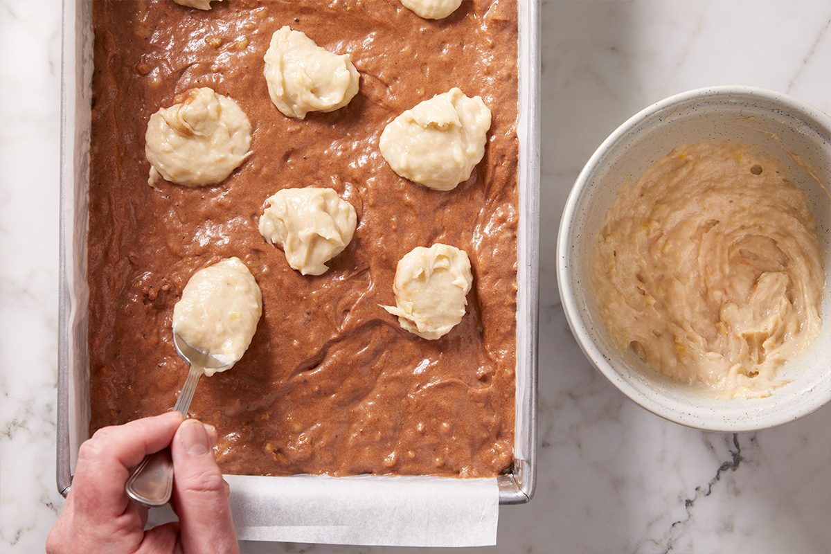 adding banana bread batter to cookie batter